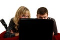 Two young people working on a laptop lying Royalty Free Stock Photo