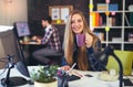 Two young people working on their computers, focus on the woman Royalty Free Stock Photo