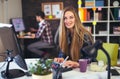 Two young people working on their computers, focus on the woman Royalty Free Stock Photo