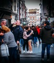 Two young persons embrace each other among the chaos of a busy commercial street in Madrid, Spain