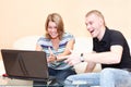 Two young persons playing in games on laptop.