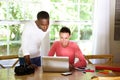 Two young photo artists using a laptop