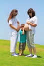 Two young pregnant women and a small son Royalty Free Stock Photo