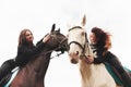 Two young pretty girls riding a horses on a field. They loves animals andhorseback riding Royalty Free Stock Photo