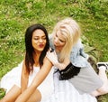 Two young pretty teenager girls best friends laying on grass making selfie photo having fun, lifestyle happy people Royalty Free Stock Photo