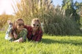 Two young pretty teenager girls best friends laying on grass at sunny summer day Royalty Free Stock Photo