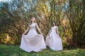 Two young princess wearing nice beige dress in autumn park. Fashion photo