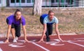 Two young race competitors crouched at the start