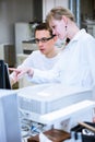 Two young researchers carrying out experiments in a lab Royalty Free Stock Photo