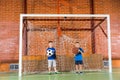 Two young school friends on an indoor court