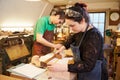 Two young shoemakers preparing shoe lasts in a workshop Royalty Free Stock Photo