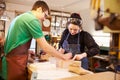 Two young shoemakers preparing shoe lasts in a workshop Royalty Free Stock Photo