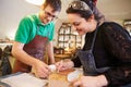 Two young shoemakers preparing shoe lasts in a workshop Royalty Free Stock Photo