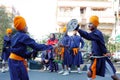 Two young sikh children performing martial arts