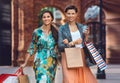 Two young fashion women with shopping bags in the city Royalty Free Stock Photo