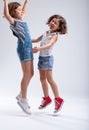 Two young sisters jumping and laughing