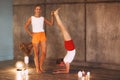 Two young slender women in colorful sportive wears doing yoga for relax, attractive females performing stretching exercise