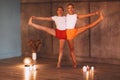 Two young slender women in colorful sportive wears doing yoga for relax, attractive females performing stretching exercise