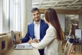 Business people man and woman discussing work project in office sitting with laptop. Royalty Free Stock Photo