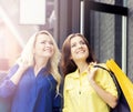 Two young and smiling women being happy after shopping. Royalty Free Stock Photo