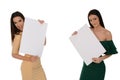 Two young smiling women holding two pieces of blank paper Royalty Free Stock Photo