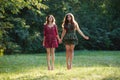 Two young smiling women levitate