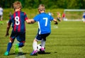 Young Boys Kicking Football Match