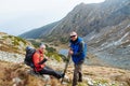 Two young sports men are sitting on top of the mountain with sporting gear Royalty Free Stock Photo