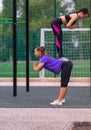 Two young sportswomen doing acrobatic yoga