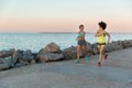 Two young sportswomen running together and talking