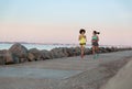 Two young sportswomen running together and talking