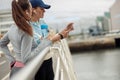 Two young sporty woman standing on bridge and have a rest after morning running in city Royalty Free Stock Photo