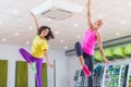 Two young sporty women exercising in fitness studio, dancing, doing cardio, working on balance and coordination. Royalty Free Stock Photo