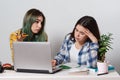 Two young student girls with laptops studying together at the table Royalty Free Stock Photo