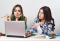 Two young student girls with laptops studying together at the table Royalty Free Stock Photo