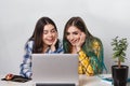 Two young student girls with laptops studying together at the table Royalty Free Stock Photo