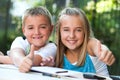 Kids doing thumbs up at desk. Royalty Free Stock Photo