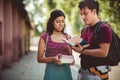 Young students standing on street with books and talking Royalty Free Stock Photo