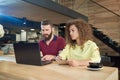 Two young students working for educational project sitting in cafe. Royalty Free Stock Photo