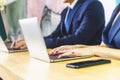 Two young stylish receptionists at a reception desk, two use taplet on the desk Royalty Free Stock Photo