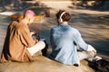 Two young stylish students boys sitting with backs to camera Royalty Free Stock Photo