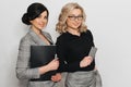 Two young successful girls in business suits with documents and mobile phone Royalty Free Stock Photo