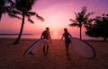 Two young surfers going into the sea with surf boards Royalty Free Stock Photo