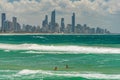 Two young surfers with Gold Coast cityscape on the background