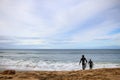 two surfers running with their surfboards to join the surf, coastal Victoria, great ocean road, Australia