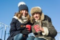 Two young teenage girls having fun outdoors, girlfriends in winter clothes, positive people and friendship concept. Royalty Free Stock Photo