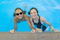 Two young teenage girls having fun in the swimming pool Royalty Free Stock Photo