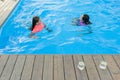 Two young teenage girls having fun in the swimming pool. Royalty Free Stock Photo