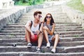 Two young tourists taking a break on old stairway Royalty Free Stock Photo