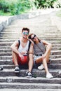 Two young tourists taking a break on old stairway Royalty Free Stock Photo